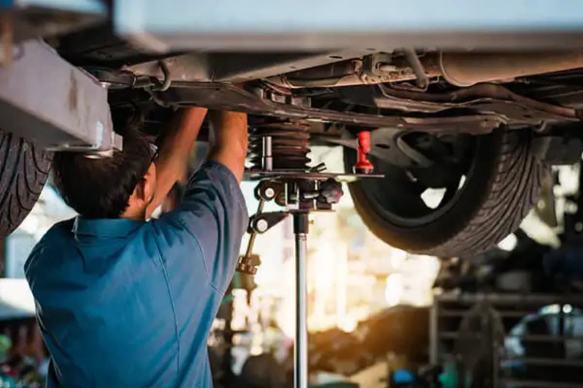 Auto technician working on vehicle